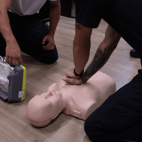 OHS Paramedics administering CPR to a Practice Doll
